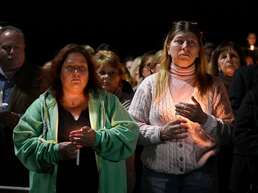 PHOTO: Maria Busch, left, and Tammy Smith, both of Amsterdam, New York, gather with family and friends for a candlelight memorial at the Overhaw Bridge pedestrian bridge at Mohawk Valley Gateway in New York York, Monday, October 8, 2018. 