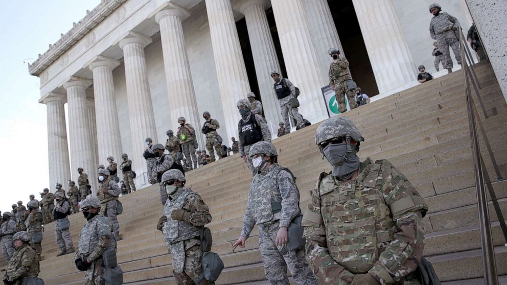 PHOTO: In this June 2, 2020, file photo, members of the D.C. National Guard stand on the steps of the Lincoln Memorial in Washington, D.C., as demonstrators participate in a peaceful protest against police brutality and the death of George Floyd.
