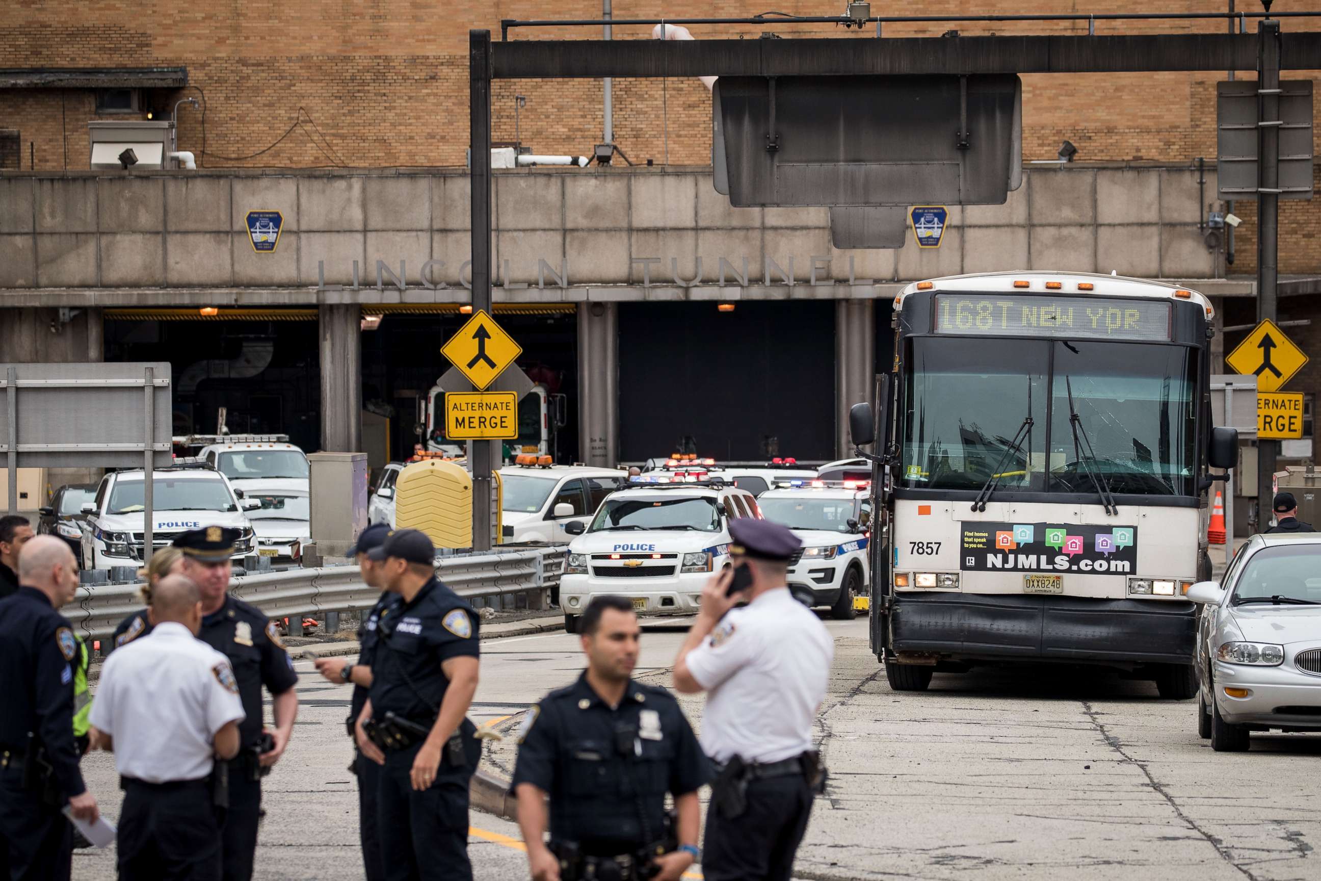 PHOTO: Law enforcement officials gather near the scene of a New Jersey Transit bus that was involved in a morning crash near the Manhattan entrance to the Lincoln Tunnel, May 18, 2018 in New York.