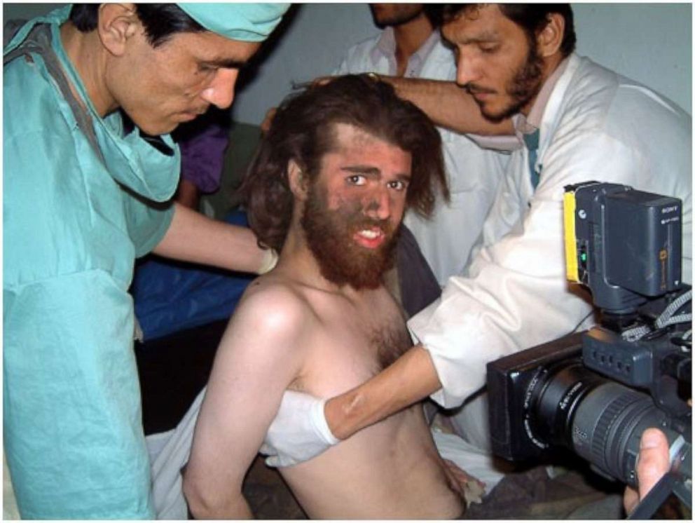 PHOTO: A soot-covered Lindh was later interviewed by war author Robert Young Pelton as he received medical care, and photographed by the U.S. military blind-folded and strapped naked to a stretcher.