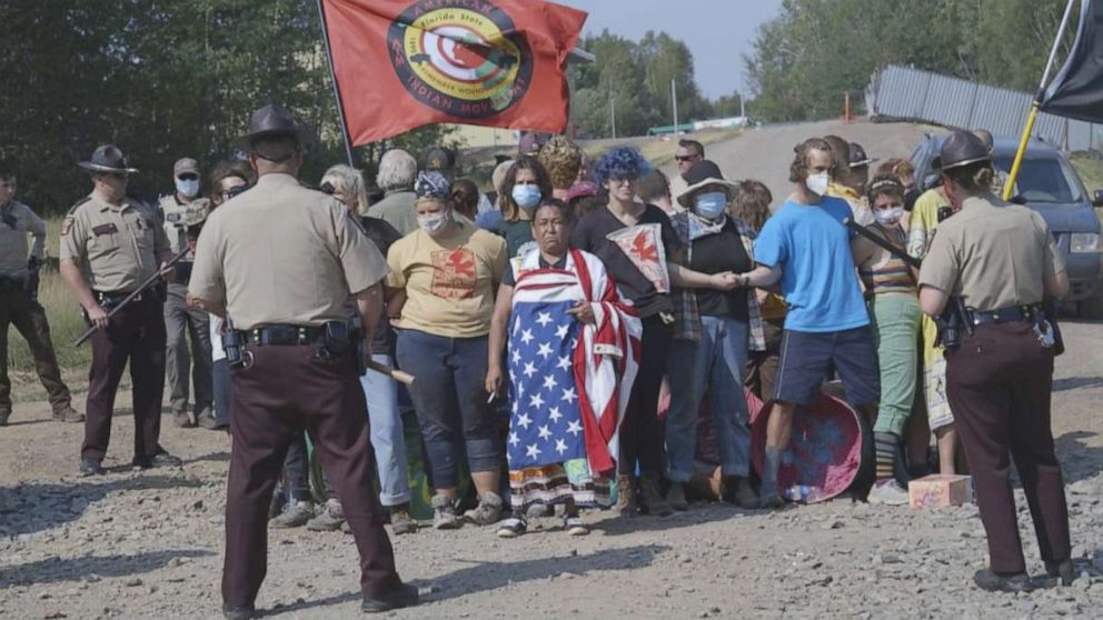 PHOTO: Police respond to members of a pipeline opposition camp during a "direct action" against the Line 3 pipeline.