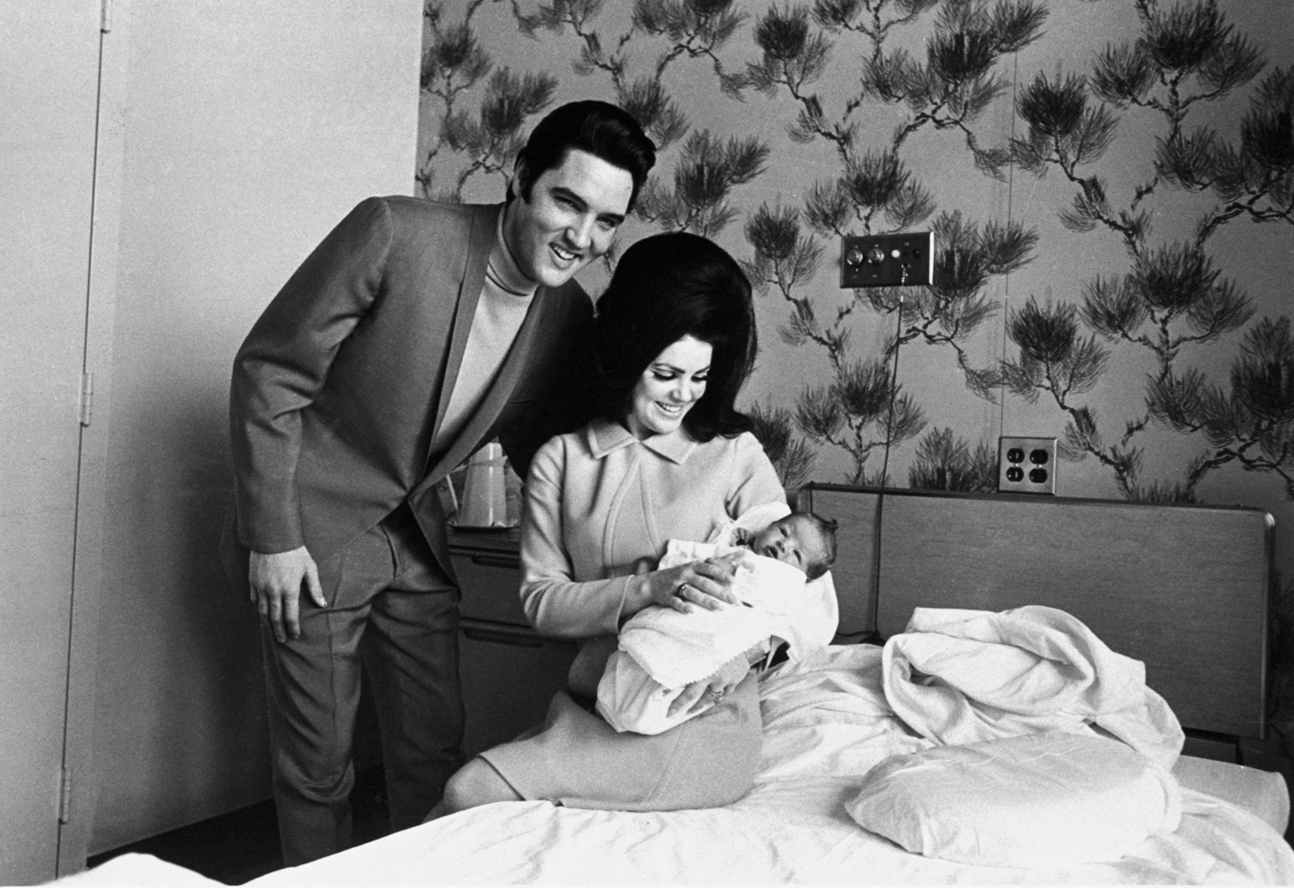 PHOTO: Lisa Marie Presley poses for her first picture in the lap of her mother, Priscilla, on Feb. 5, 1968, with her father, Elvis Presley.