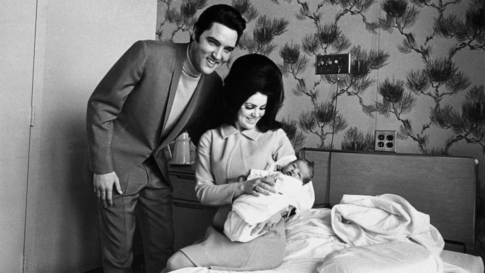 PHOTO: Lisa Marie Presley poses for her first picture in the lap of her mother, Priscilla, on Feb. 5, 1968, with her father, Elvis Presley.