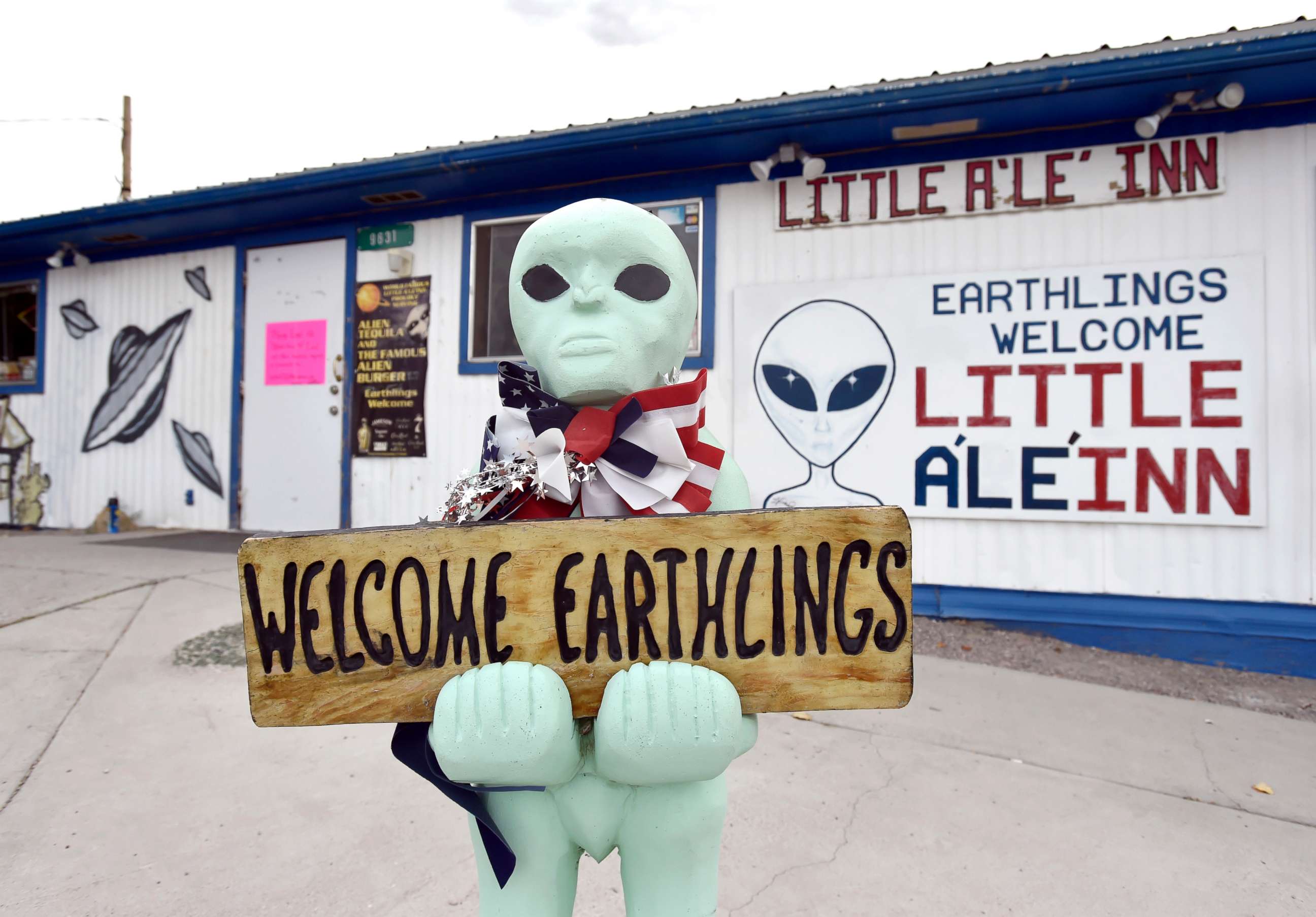 PHOTO: An alien-like statue displays a sign welcoming guests to the Little A'le' Inn restaurant and gift shop, July 22, 2019, in Rachel, Nevada.