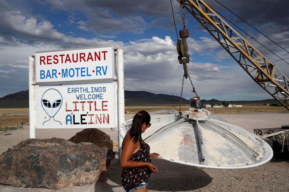 PHOTO: Grace Capati looks at a UFO display outside of the Little A'Le'Inn, in Rachel, Nev., the closest town to Area 51, July 22, 2019.