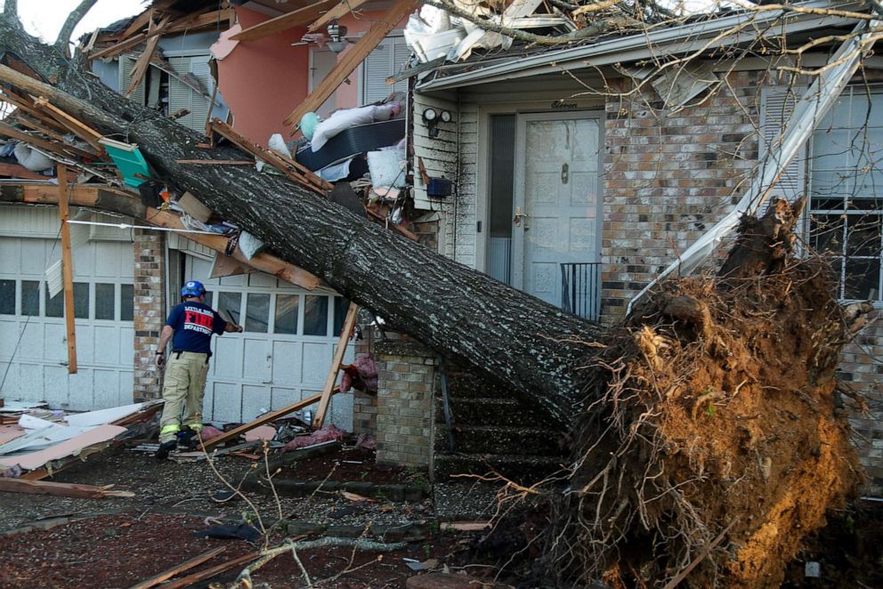 PHOTO: A firefighter checks homes for injured residents in the Walnut Ridge neighborhood after a tornado damaged hundreds of homes and building on March 31, 2023, in Little Rock, Arkansas.