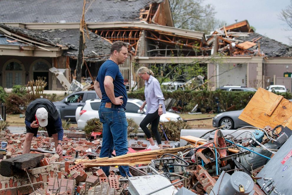 PHOTO: Kris French (C) and his family search through rubble after a tornado damaged hundreds of homes and building on March 31, 2023, in Little Rock, Arkansas.