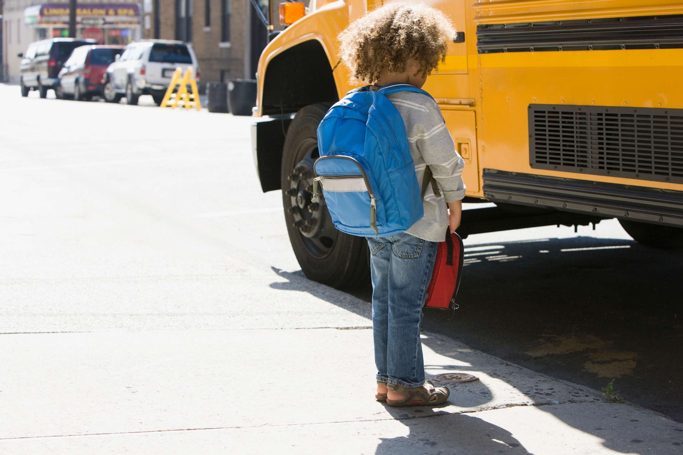 PHOTO: This stock photo shows a student standing by a school bus.