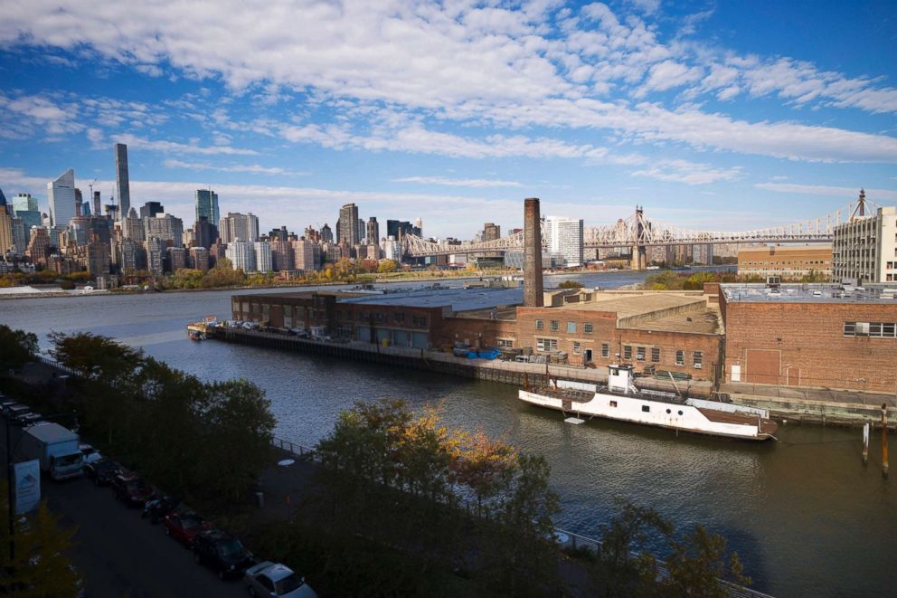 PHOTO: A rusting ferryboat is docked next to an aging industrial warehouse on Long Island City's Anable Basin in New York.