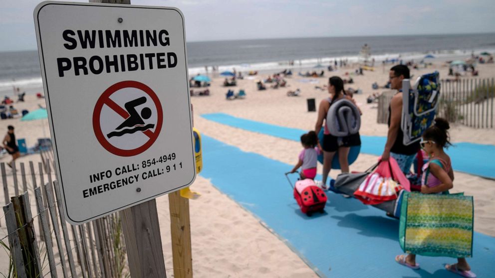 PHOTO: Beach-goers enjoy the surf at Smith Point County Park, a Long Island beach where a shark bit a lifeguard 10 days earlier, July 15, 2022, in Shirley, N.Y. Shark sightings were relatively rare in the region until recently.