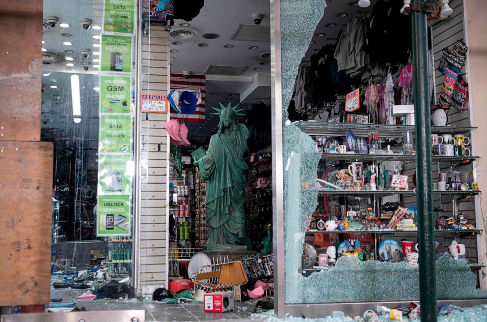 PHOTO: A looted souvenir shop is seen after a night of protest over the death of an African American man, George Floyd, in Minneapolis on June 2, 2020, in Manhattan in New York City. 