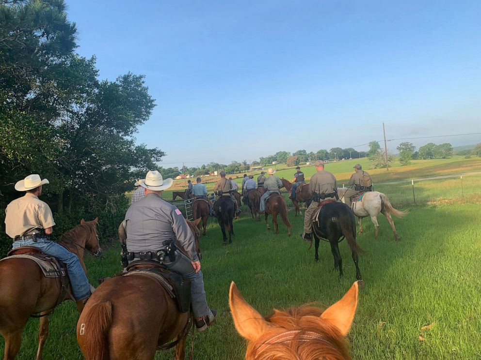 PHOTO: In a photo released by the Texas Department of Criminal Justice, May 15, 2022, shows members from different law enforcement agencies using horses and K9 teams to search for prison escapee Gonzalo Lopez in Leon County, Texas. 