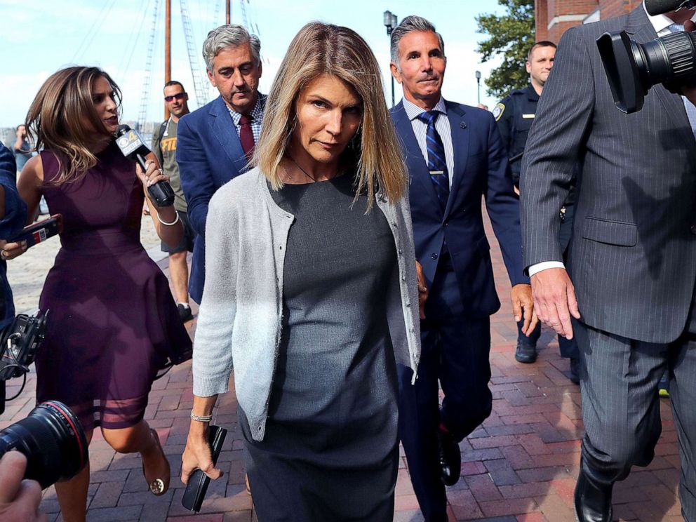PHOTO: Lori Loughlin, center, and her husband Mossimo Giannulli, behind her at right, leave the John Joseph Moakley United States Courthouse in Boston on Aug. 27, 2019.