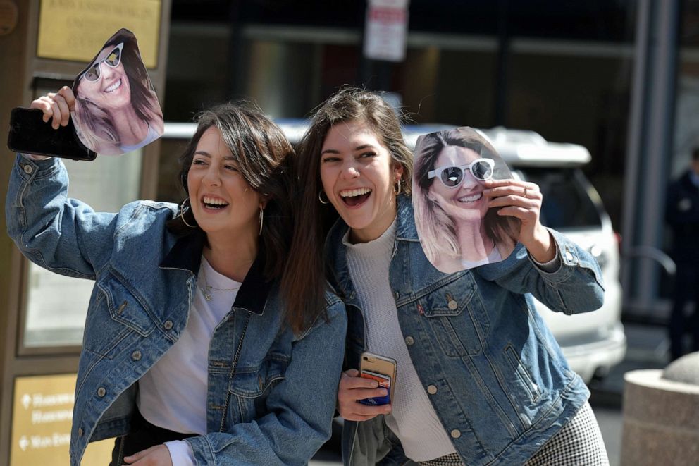 PHOTO: Fans of Lori Loughlin hold photo masks of Loughlin before she enters a courthouse in Boston to answer charges stemming from college admissions scandal on April 3, 2019.