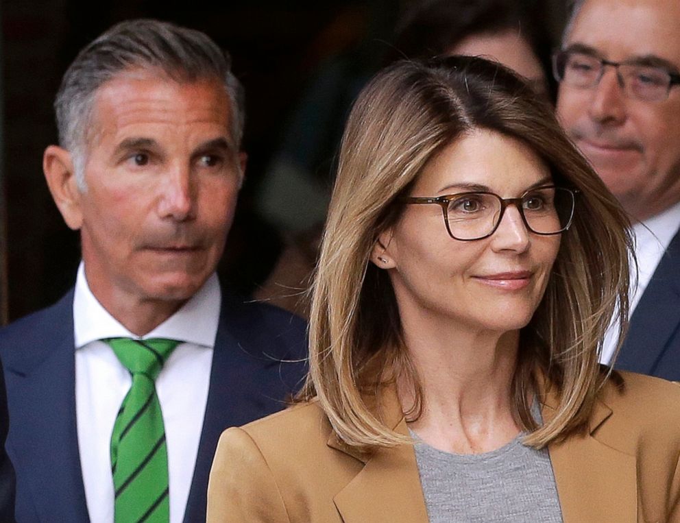 PHOTO: In this April 3, 2019, file photo, actress Lori Loughlin, front, and her husband, clothing designer Mossimo Giannulli, left, depart federal court in Boston after facing charges in a nationwide college admissions bribery scandal.
