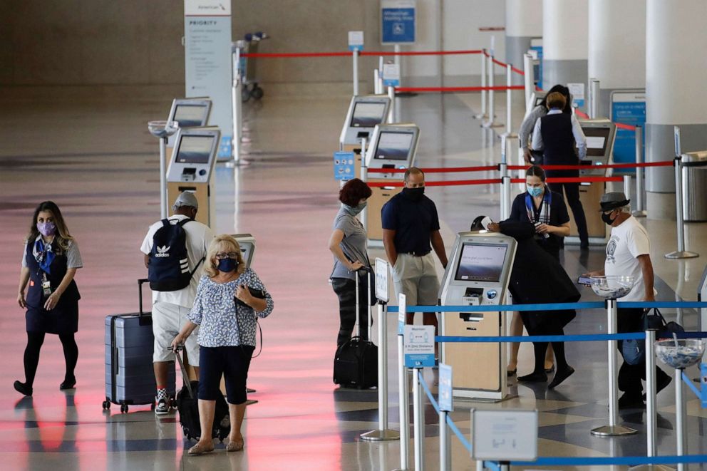 PHOTO: Travelers check in at the American Airlines terminal at the Los Angeles International Airport, May 28, 2020, in Los Angeles.
