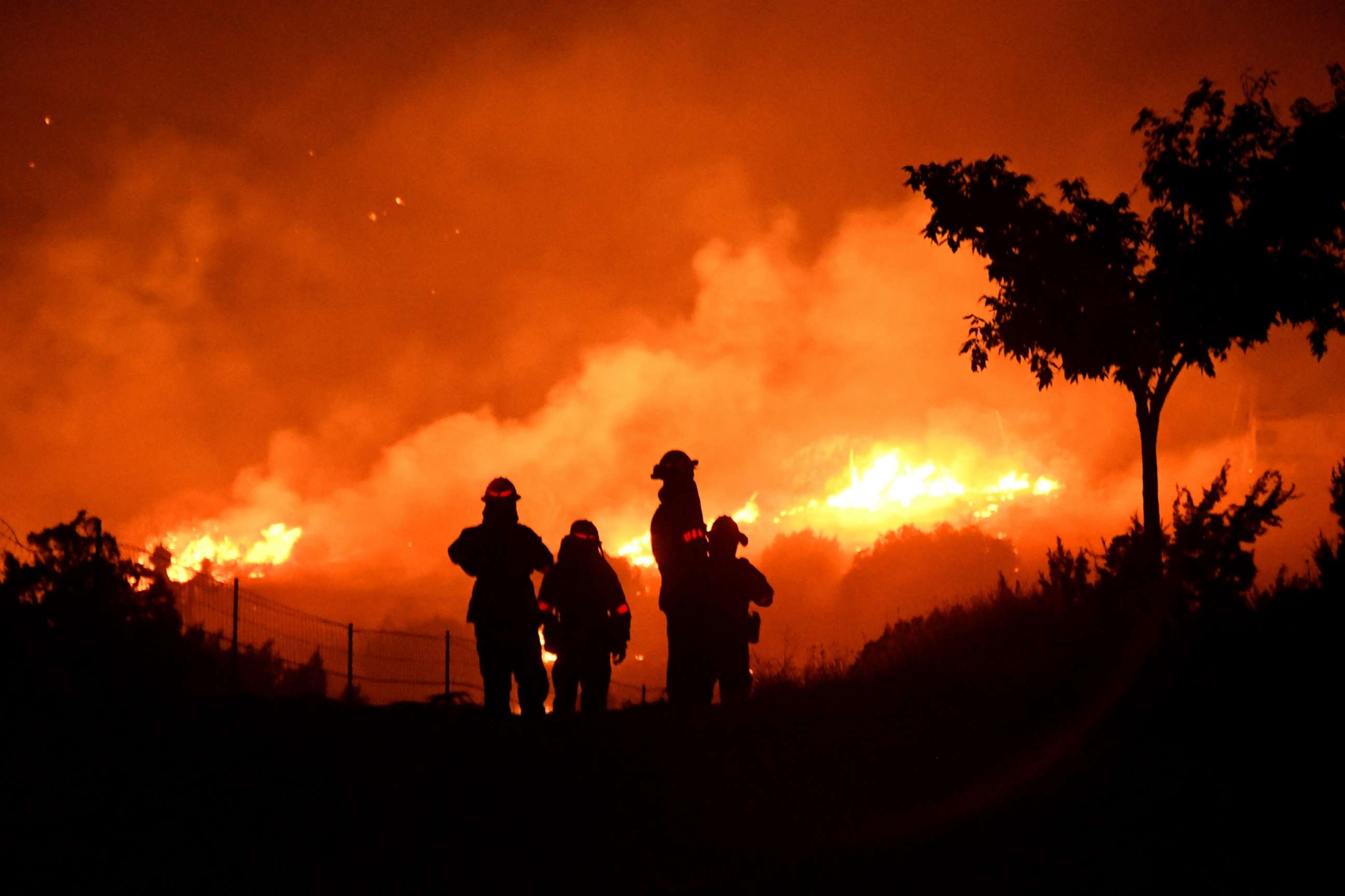 PHOTO: Los Angeles County firefighters keep watch on the Bobcat Fire as it burns through the night in Juniper Hills, California, on September 19, 2020.