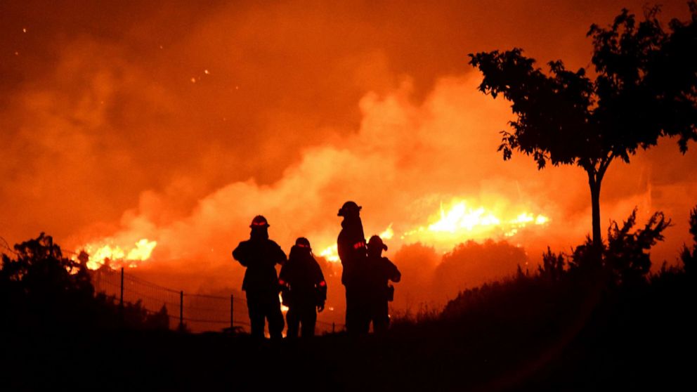 PHOTO: Los Angeles County firefighters keep watch on the Bobcat Fire as it burns through the night in Juniper Hills, California, on September 19, 2020.