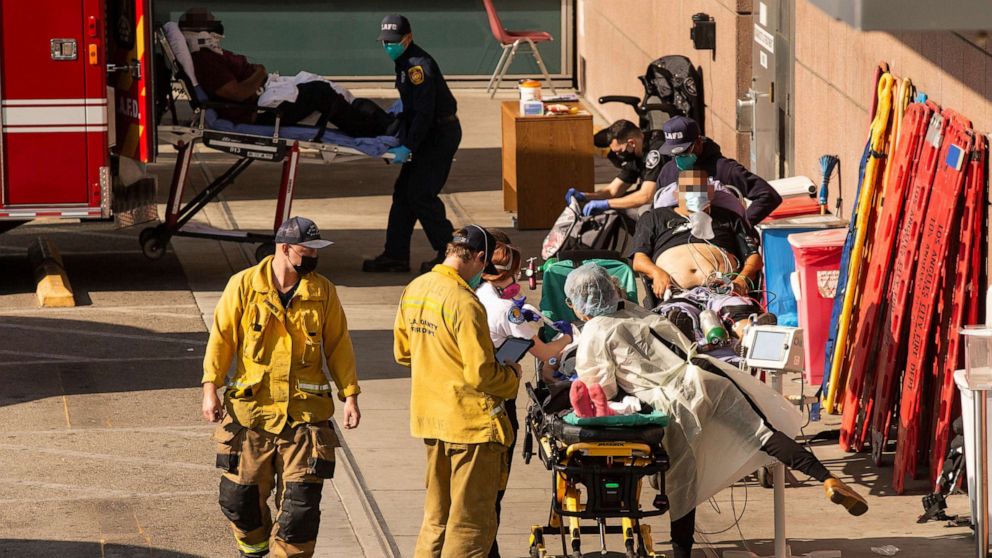 PHOTO: Patients brought in by ambulance wait outside the Emergency Room at the LAC USC Hospital ER amid the coronavirus pandemic in Los Angeles, Jan. 5, 2021.