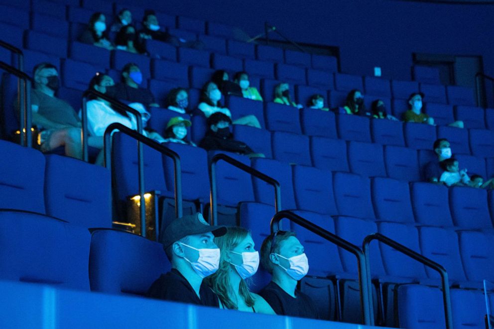 PHOTO: Visitors wearing protective masks watch a film inside a theater at the Aquarium of the Pacific in Long Beach, Calif., July 16, 2021.
