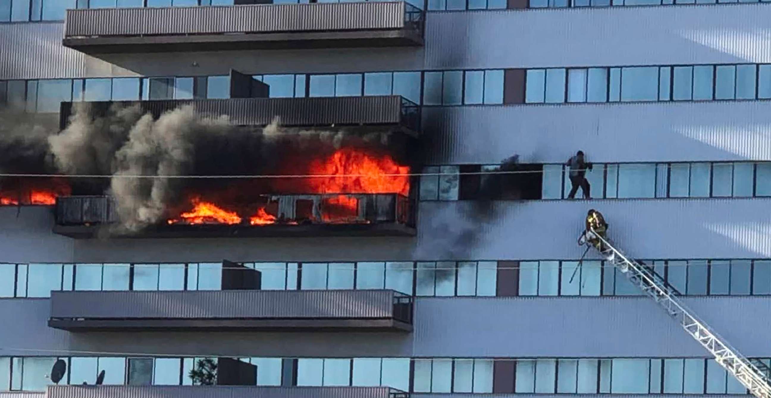 PHOTO: This image from video shows a Los Angeles Fire Department firefighter on a ladder rescuing a man who had climbed out on the side of a 25-story high-rise apartment after a fire broke out on a sixth-floor balcony in West Los Angeles Jan. 29, 2020.