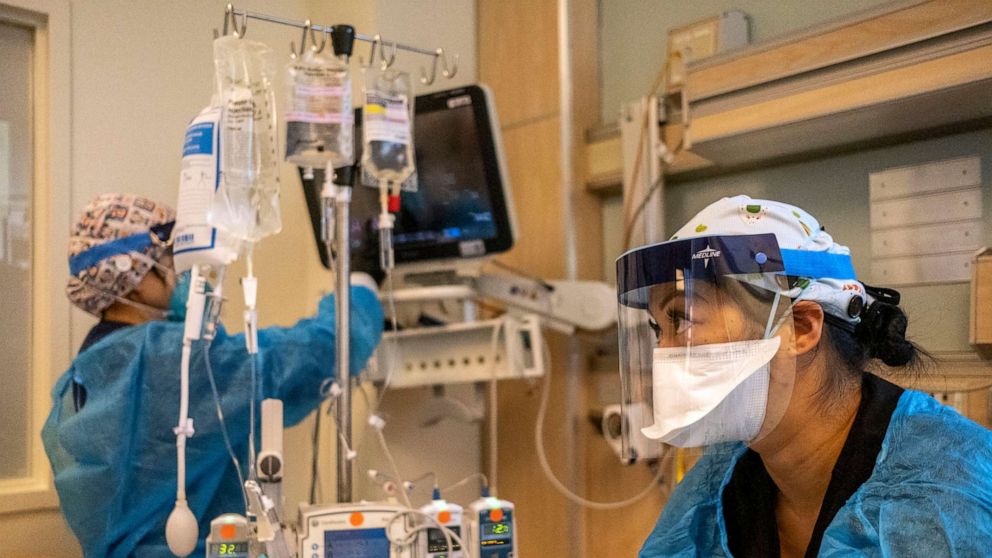PHOTO: In this Dec. 31, 2021, file photo, a nurse and a respiratory therapist work inside the ICU with a COVID-19 positive patient at Martin Luther King Jr. Community Hospital in Los Angeles.