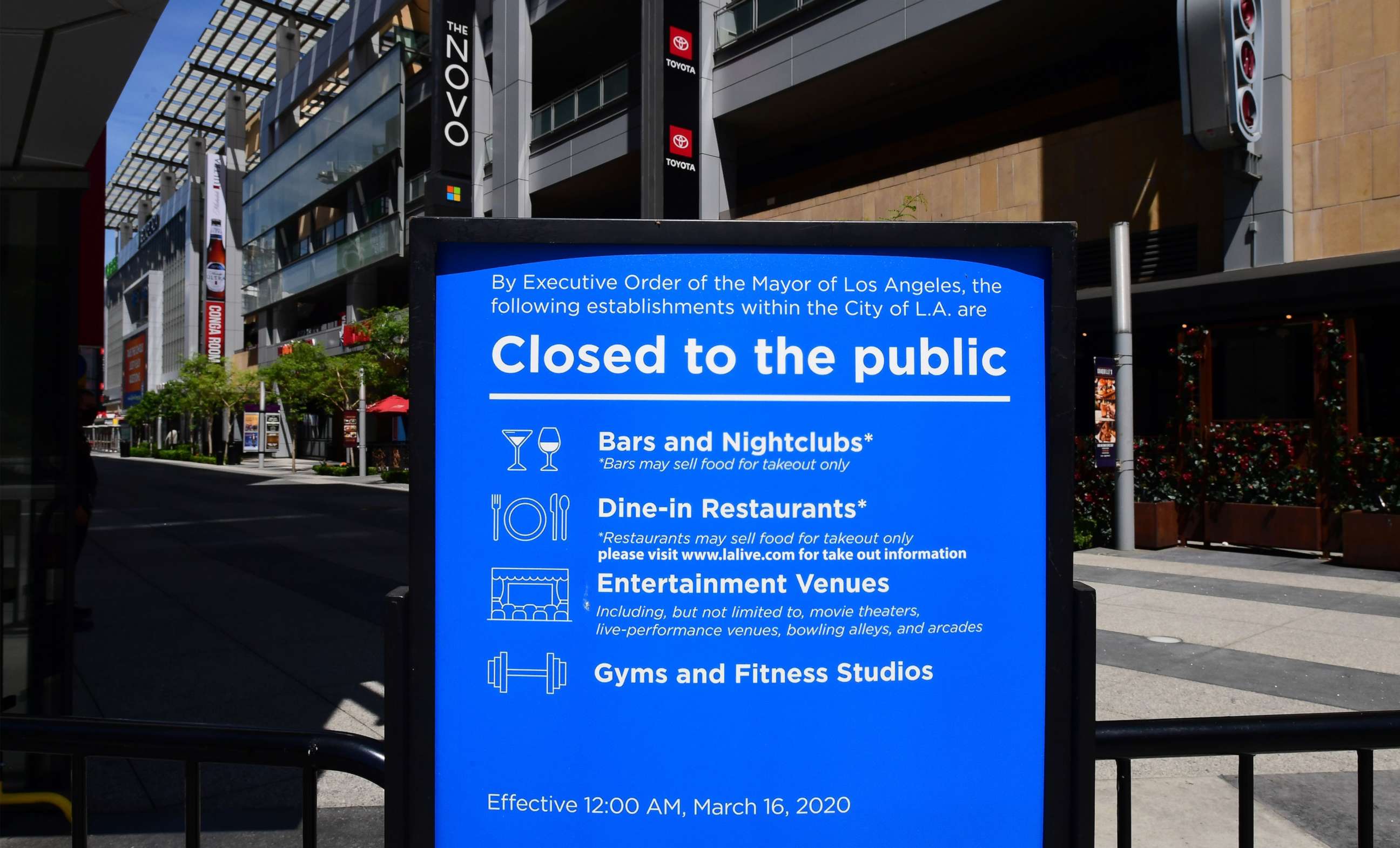 PHOTO: In this file photo taken on May 7, 2020, a sign that's been in place since mid-March announces the temporary closures of restaurants, nightclubs, gyms and entertainment venues at LA Live in Los Angeles, California.