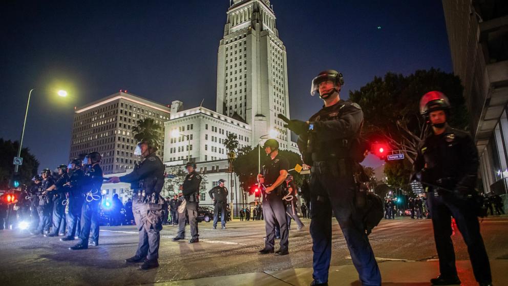 PHOTO: Los Angeles Metro Police officers stand on the road in front of the City Hall after a curfew was put into effect following days of protests in response to federal immigration operations in Los Angeles on June 10, 2025.