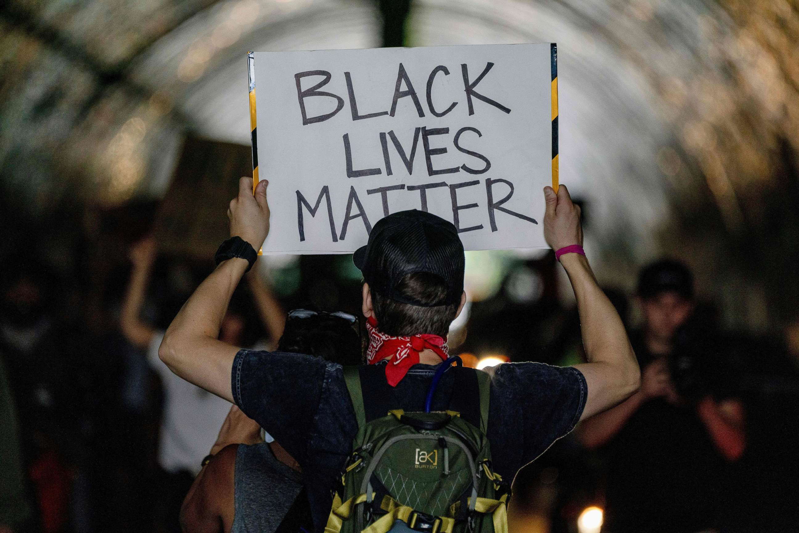 PHOTO: A protester holds up a placard as they march during a demonstration over the death of George Floyd, in Los Angeles.