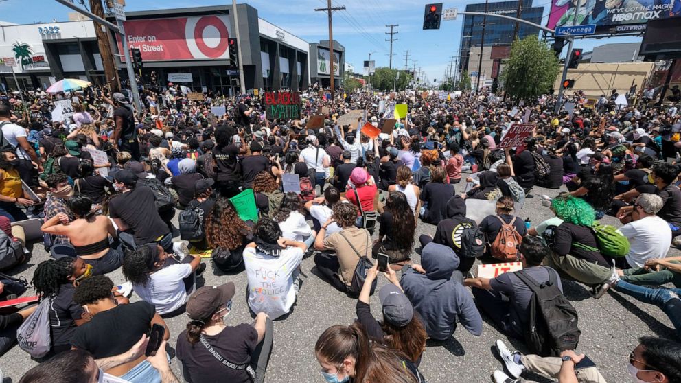 PHOTO: Peoples sit on at an intersection during a protest over the death of George Floyd in Los Angeles, May 30, 2020.