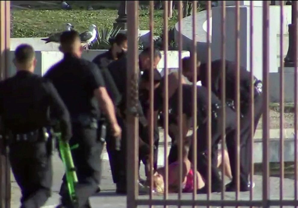 PHOTO: A woman allegedly armed with a gun was taken into custody Friday evening after a nearly three-hour long standoff with Los Angeles police, which included her swimming in MacArthur Park's lake in Los Angeles, April 2, 2021.