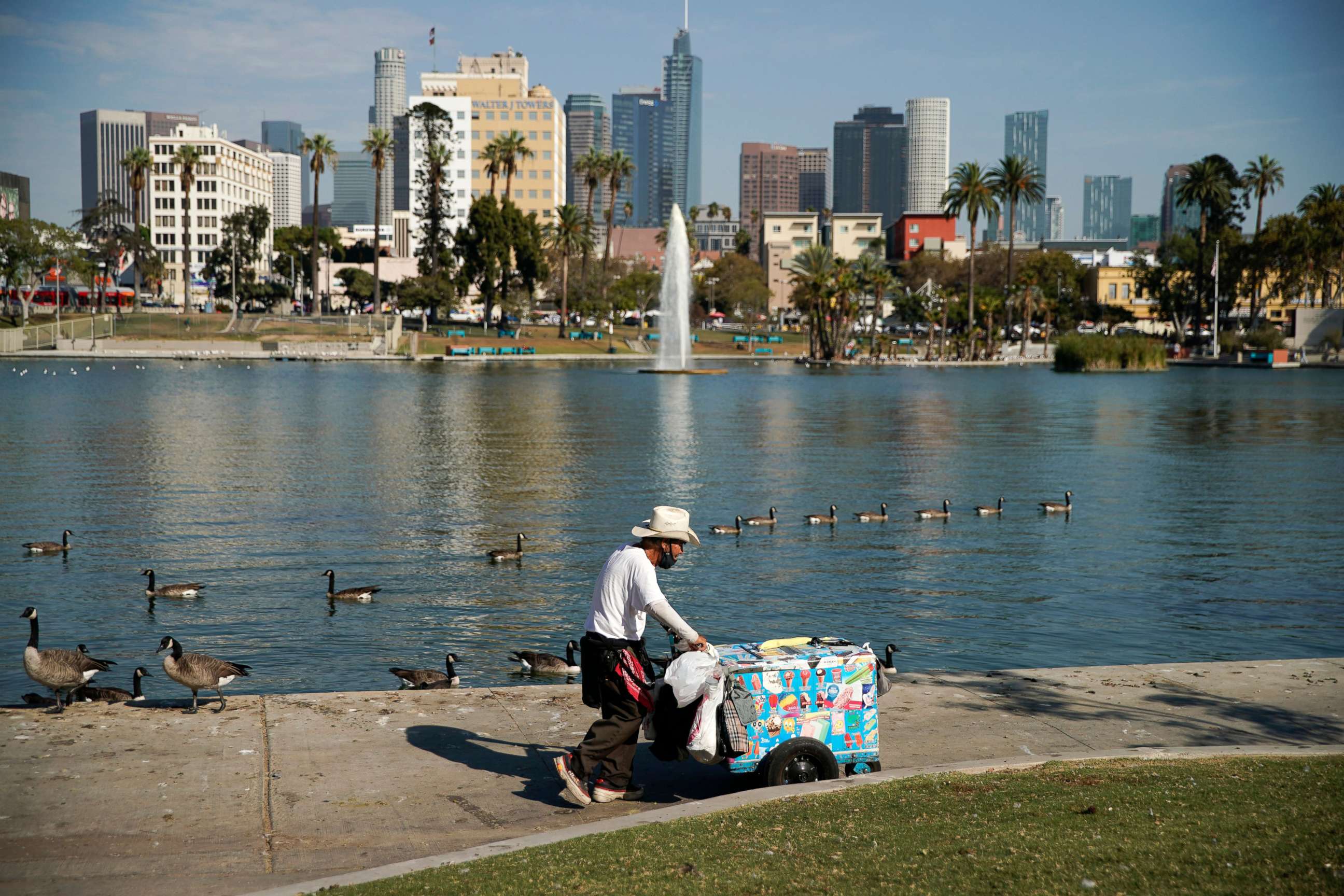 PHOTO: A vendor wheels around an ice cream cart in MacArthur Park in Los Angeles, Sept. 1, 2022.