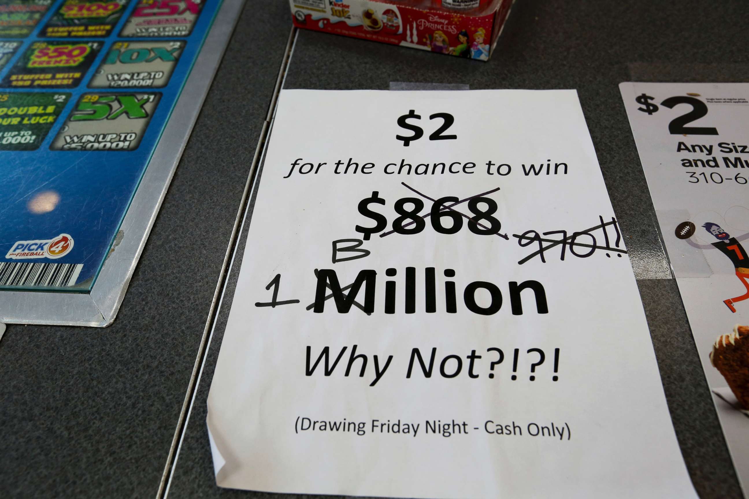 PHOTO: An updated paper sign is displayed the counter of a 7-Eleven store shows that the Mega Millions estimated jackpot has soared to $1 billion, as the second-largest prize in U.S. lottery history gets even bigger, Oct. 19, 2018, in Chicago. 
