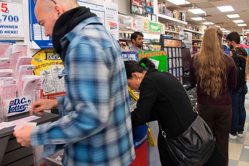 PHOTO: People stand in line to purchase Mega Millions tickets in Washington, on Oct. 19, 2018, as the jackpot nears one billion dollars.