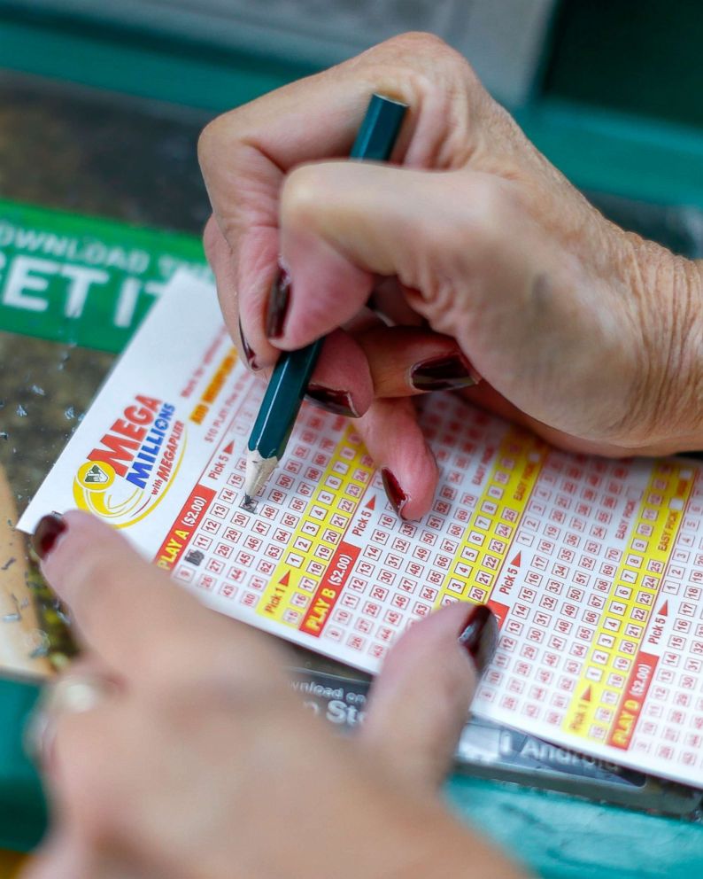 PHOTO: A customer fills out a play slip before purchasing Mega Millions lottery tickets at a retailer in Arlington, Va., Oct. 22, 2018.