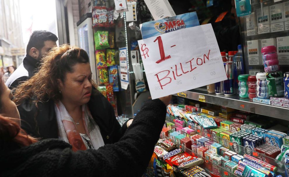 PHOTO: An impromptu "One Billion dollars" sign is on display as customers line up to buy Mega Millions tickets at a newsstand in midtown Manhattan in New York, Oct. 19, 2018.   