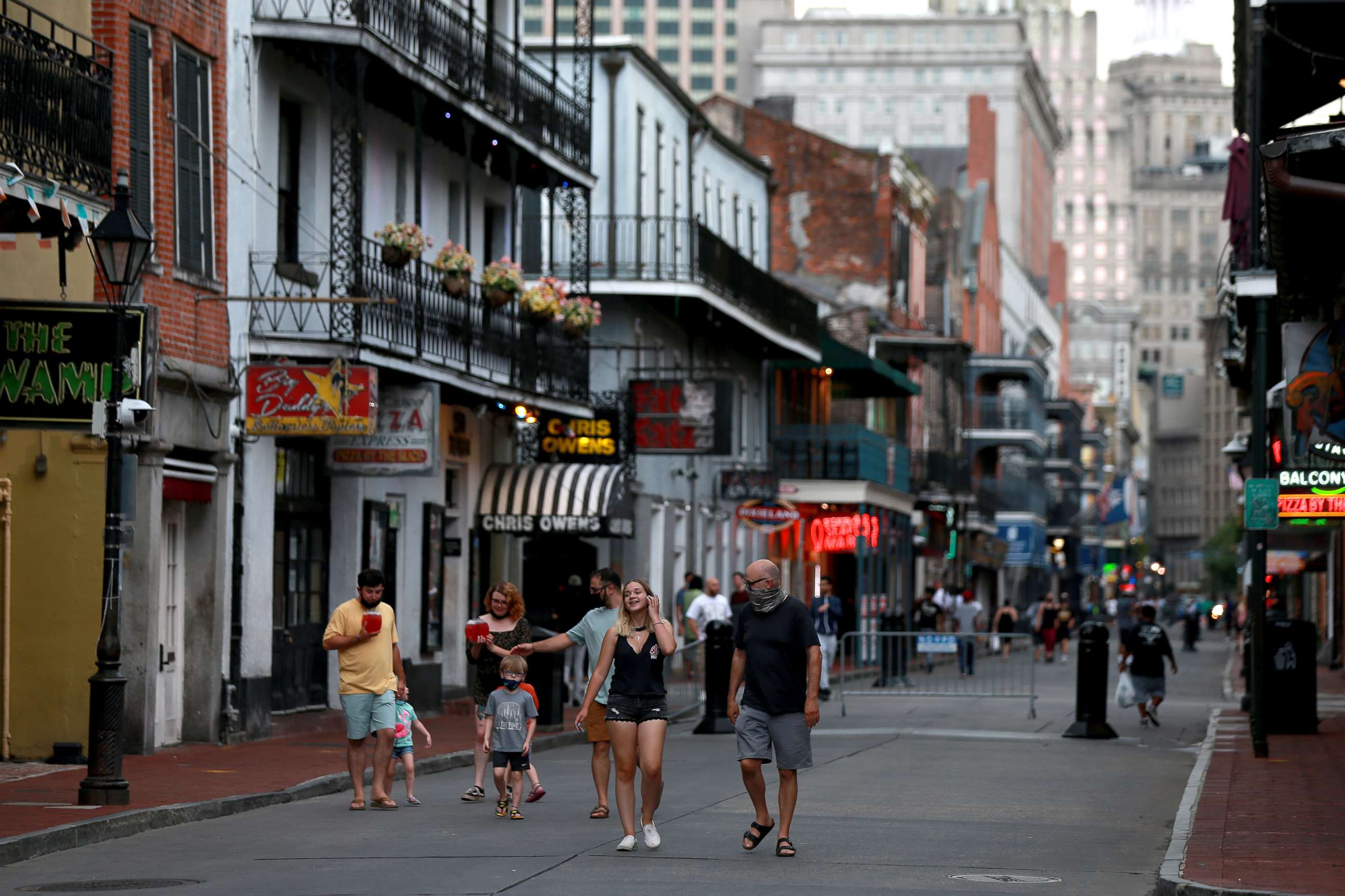 PHOTO: Pedestrians are seen walking along Bourbon Street in the French Quarter on July 14, 2020 in New Orleans.