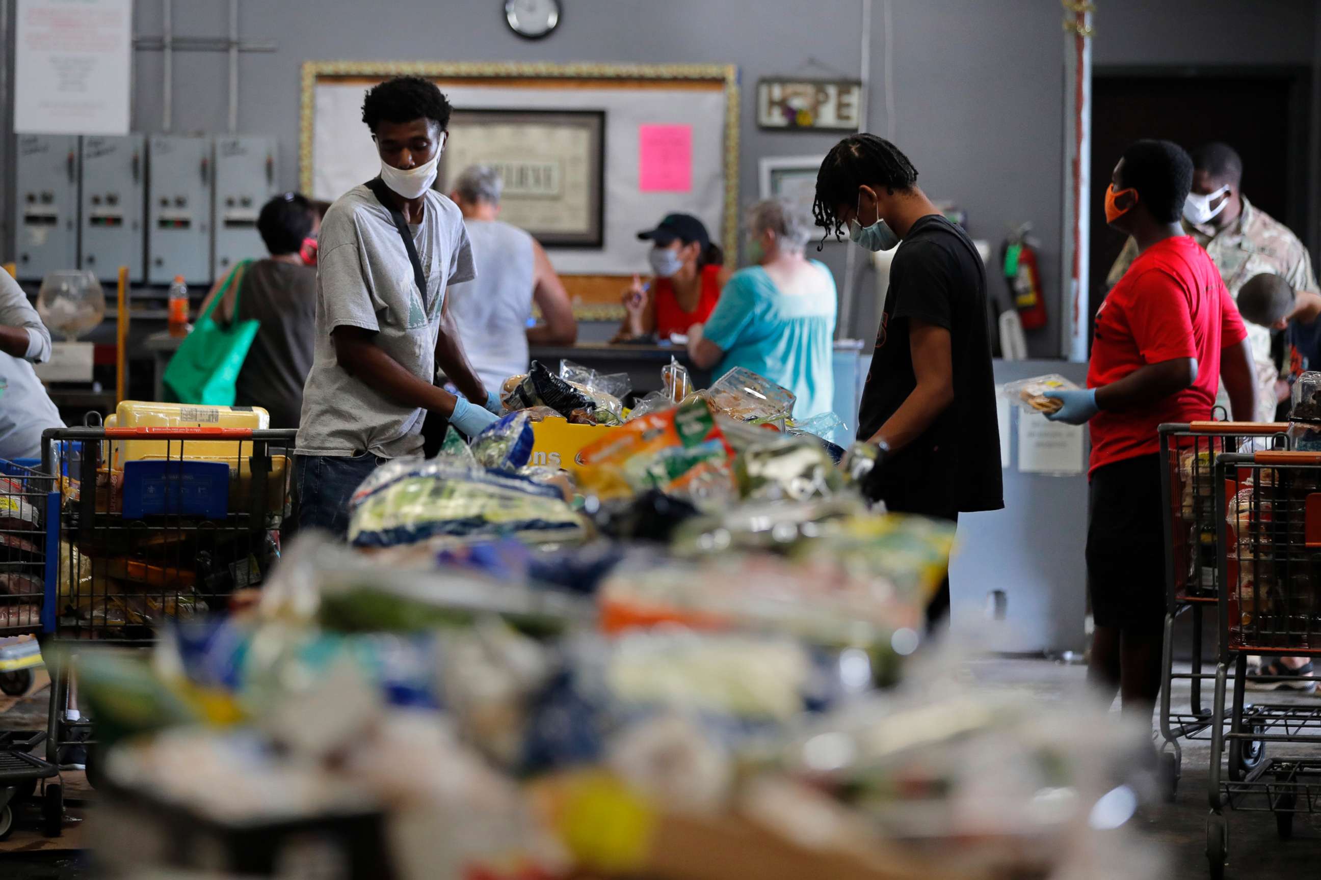PHOTO: Voluteers distribute food to recipients at the Giving Hope Food Pantry during a food giveaway in New Orleans, July 21, 2020, to assist people who have lost income during the COVID-19 pandemic.