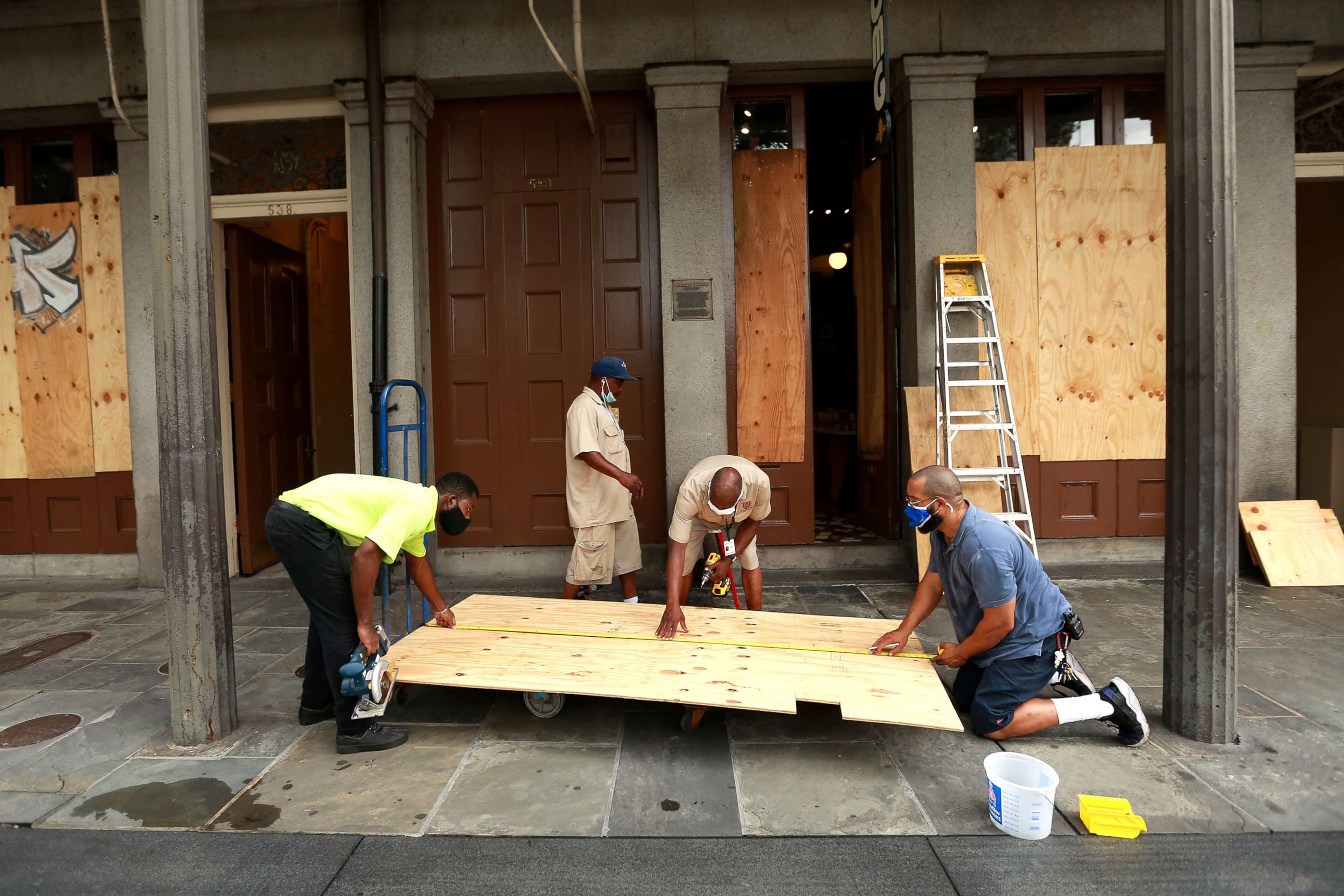 PHOTO: Workers board up windows in the French Quarter in anticipation of Hurricane Marco and Tropical Storm Laura, Aug. 23, 2020, in New Orleans.