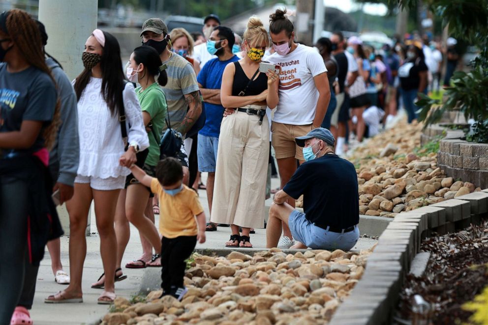 PHOTO: People stand in long lines before entering Costo to pick up supplies as they prepare for Hurricane Marco and Tropical Storm Laura, Aug. 23, 2020, in New Orleans.