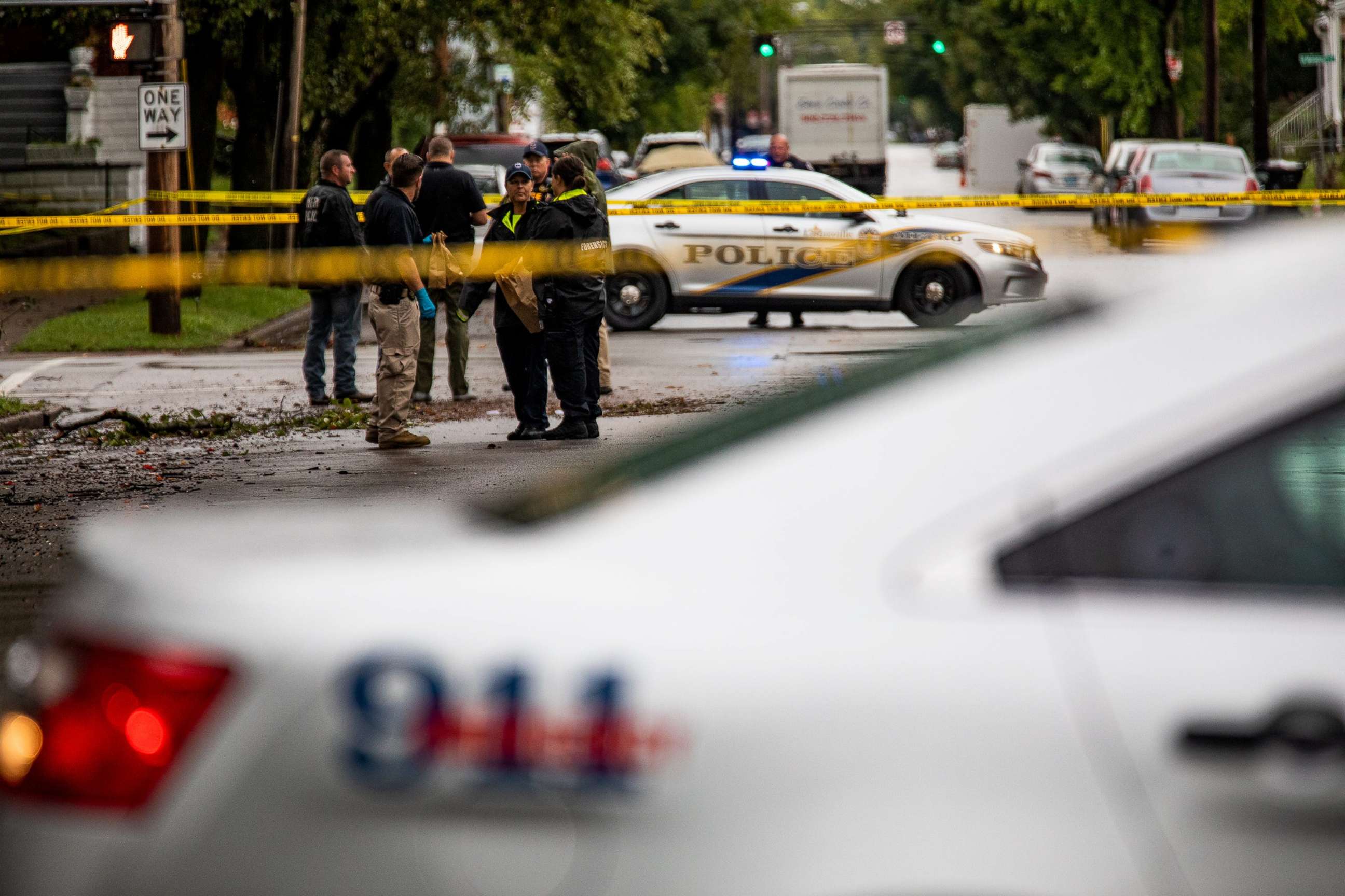 PHOTO: Police investigators stand at the corner of Dr. W.J. Hodge and W. Chestnut streets in Louisville, Ky., after a teenage boy was fatally shot and another wounded in a drive-by shooting at a bus stop, early on Sept. 22, 2021.
