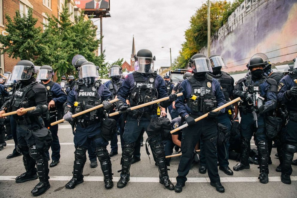 PHOTO: Law enforcement hold a line as a man is being detained during a demonstration, Sept. 23, 2020, in Louisville, Kentucky.