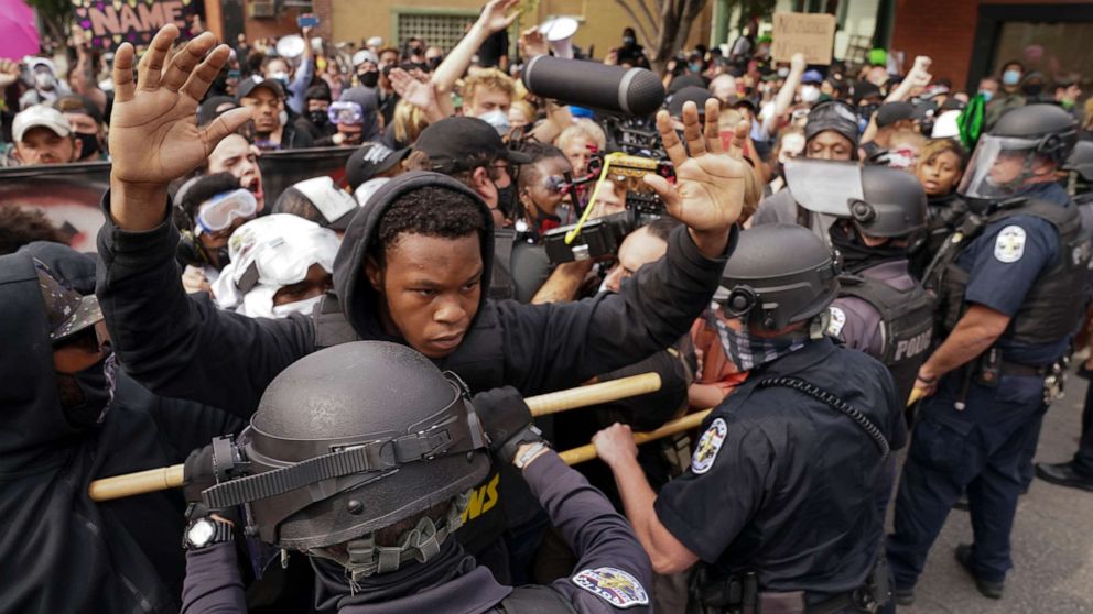 PHOTO: Police and protesters converge during a demonstration, Wednesday, Sept. 23, 2020, in Louisville, Ky. 