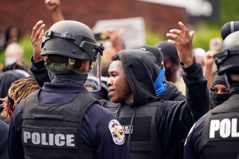 PHOTO: Police stand guard as people react after a decision in the criminal case against police officers involved in the death of Breonna Taylor, Sept. 23, 2020, who was shot dead by police in her apartment, in Louisville, Ky.