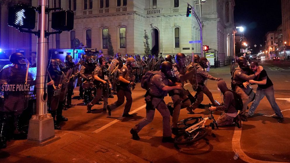 PHOTO: Kentucky State Troopers advance and detain a man during the protest against the deaths of Breonna Taylor by Louisville police and George Floyd by Minneapolis police, in Louisville, Kentucky, June 1, 2020. 