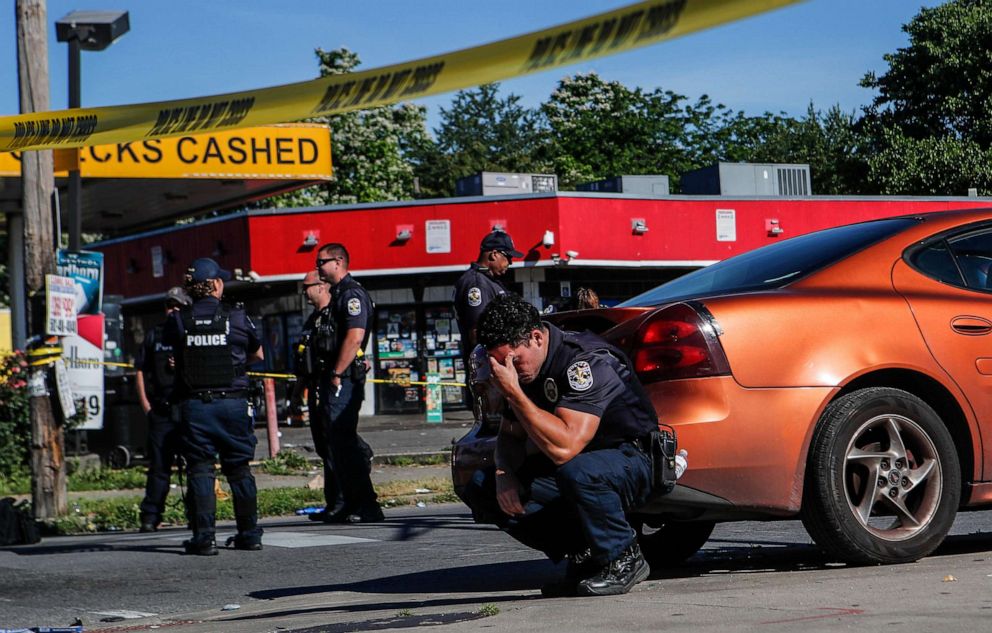 PHOTO: Louisville police stand on guard inside police tape at an intersection in Louisville, Ky., on June 1, 2020, after a man was shot and killed by police and National Guard personnel outside a market.