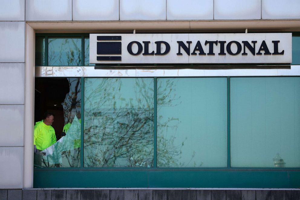PHOTO: Workers fix a shattered plate glass window one day after a shooting at the Old National Bank in downtown, Louisville, Ky., on April 10, 2023.