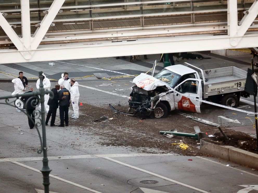 PHOTO: Authorities stand near a damaged Home Depot truck after a motorist drove onto a bike path near the World Trade Center memorial, striking and killing several people, Oct. 31, 2017, in New York.