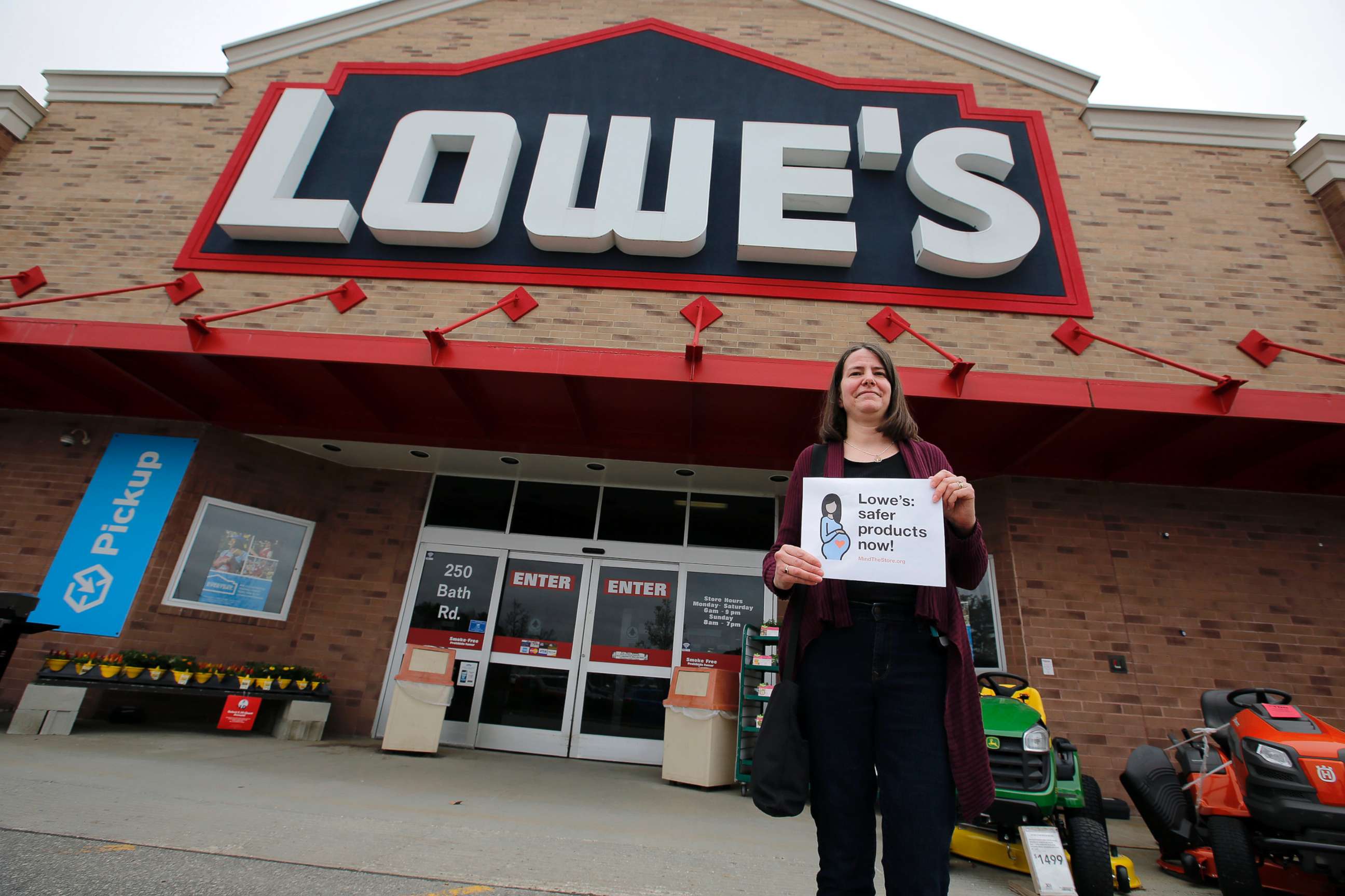 PHOTO: A woman holds a sign in front of a Lowe's store in Brunswick, Maine, while protests were held at several Maine locations in an effort to persuade Lowe's to discontinue the sale of paint strippers containing methylene chloride, May 10, 2018.