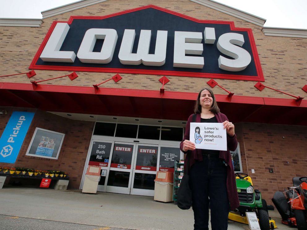 PHOTO: A woman holds a sign in front of a Lowes store in Brunswick, Maine, while protests were held at several Maine locations in an effort to persuade Lowes to discontinue the sale of paint strippers containing methylene chloride, May 10, 2018.
